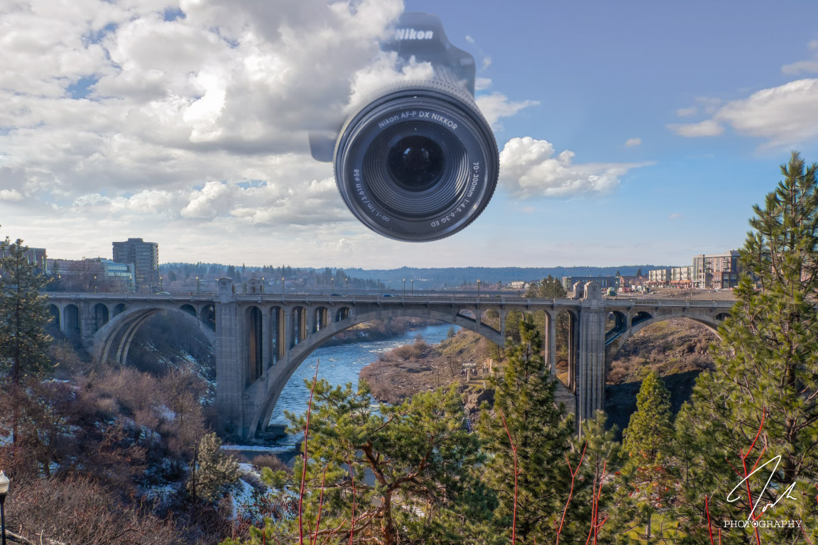 a photoshopped image of a giant camera in the sky looking directly at the viewer