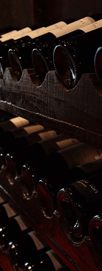 wine bottles laying on a wooden rack